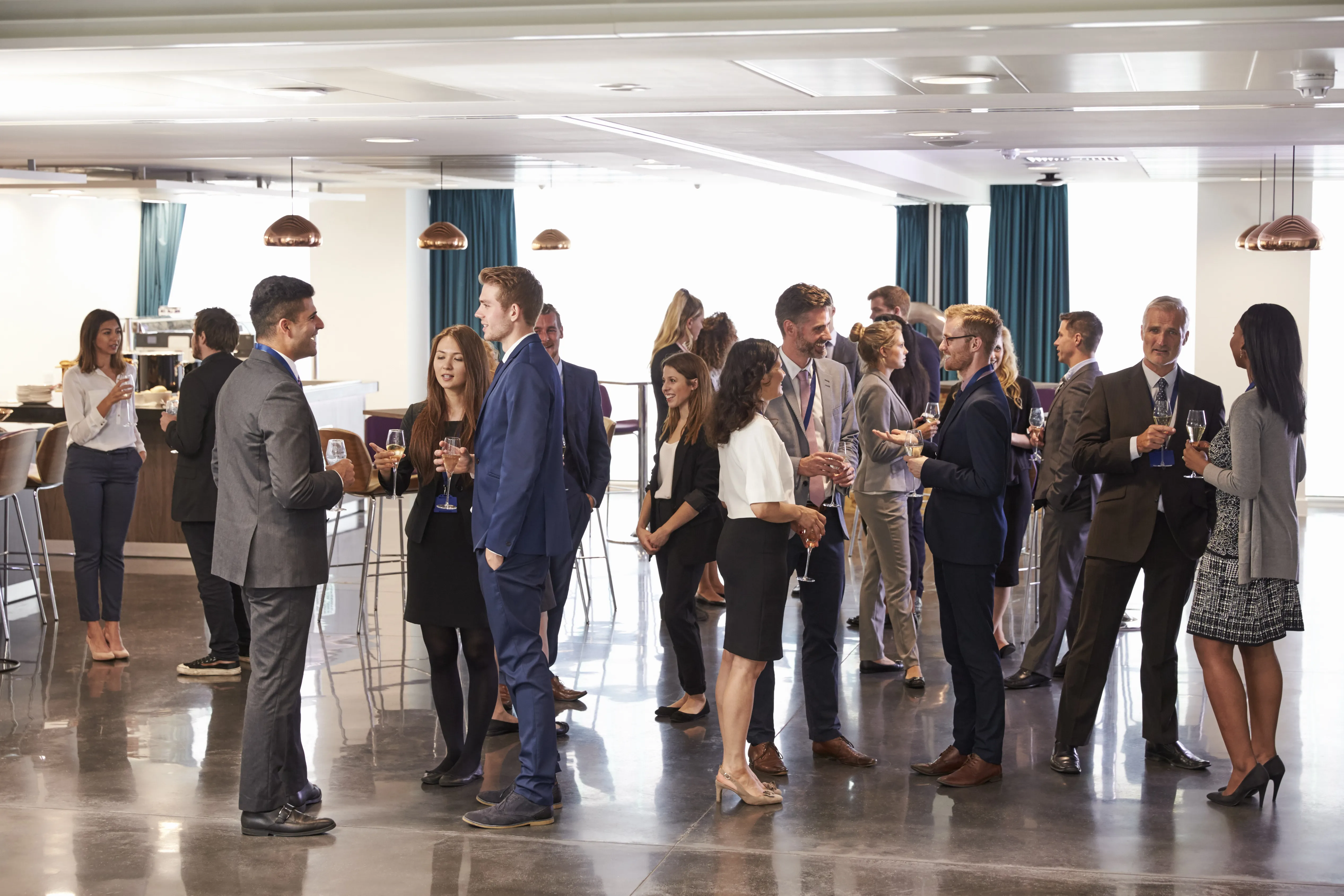 Diverse professionals networking and reviewing performance metrics at a corporate strategy session.